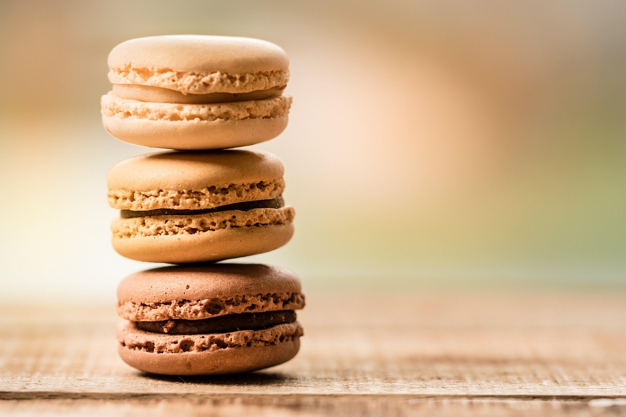 Tre macarons artigianali impilati, dal crema al cacao